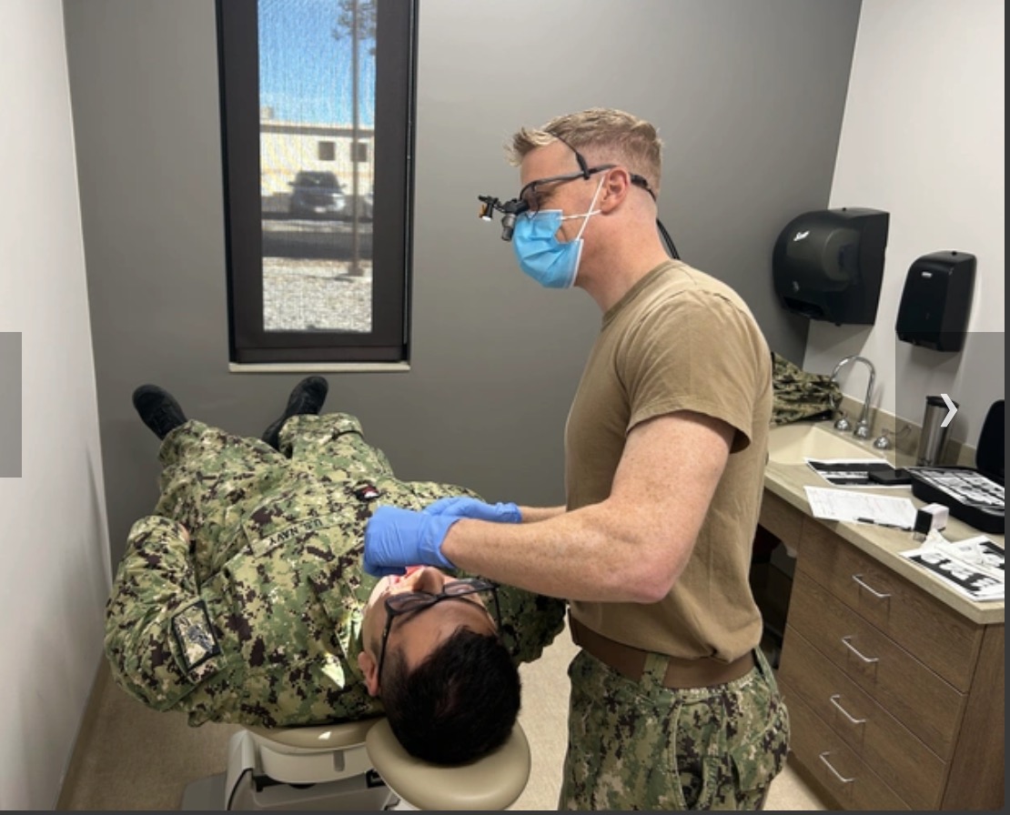 Dr. Korcek performing dental care during U.S. Navy service